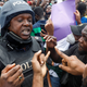 Demonstrators talk to a police officer in Lagos, Oct. 12.